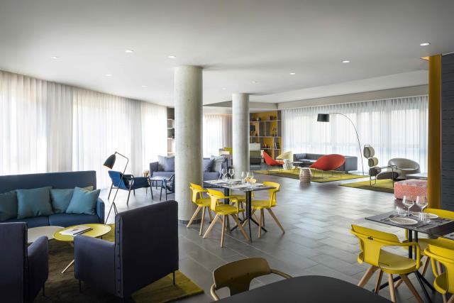 Le club, véritable coeur de l'Okko Hôtel Grenoble, est accessible 24h/24. Un lieu de détente, de petite restauration, de travail tout en couleurs et en douceur imaginé par le designer Patrick Norguet.