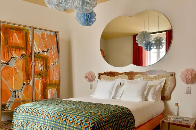 Armoire peinte, tête de lit cannée, luminaires… Tout le mobilier des chambres a été conçu par l'artiste