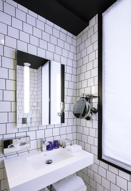 Miroir et lumière indirecte dans une salle de bains de l'hôtel Best Western Premier Faubourg 88, à Paris (10e).