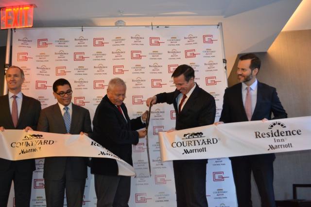 Arne Sorenson, p.-d.g. de Marriott, coupe le ruban d'inauguration du Courtyard-Residence Inn Central Park.