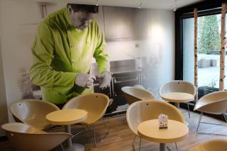 La préparation d'un burger selon Pascal Favre d'Anne s'affiche en photo dans le restaurant VF de...