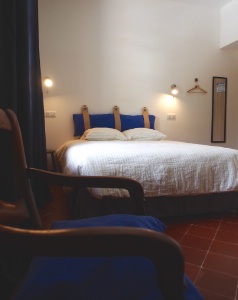 La chambre, équipée d'un poêle à bois, évoque 'l'ambiance pastorale et sobre d'une cabane d'estive'. La chambre, équipée d'un poêle à bois, évoque 'l'ambiance pastorale et sobre d'une cabane d'estive'.