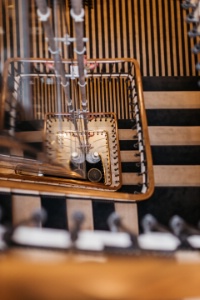 La cage d'escalier baignée de lumière, sous une verrière d'atelier en verre armé d'époque.