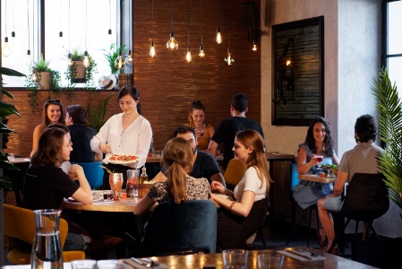 Les serveurs proposent à table des pizzas à la part. Les serveurs proposent à table des pizzas à la part.